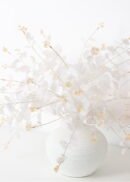 A pack of 10 artificial eucalyptus bushes, each 20" tall in a champagne hue, features thin stems fanning outward with delicate leaves, arranged against a plain white background.