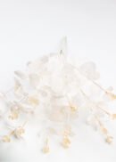 A pack of 10 artificial eucalyptus bushes, 20" tall in champagne color, with delicate foliage and cream accents is artfully arranged on a white background.
