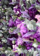 A close-up of the 8x8ft Purple Lilac Eucalyptus Hydrangea Rose Flower Wall reveals vibrant purple blooms, lavender sprigs, and green eucalyptus leaves for a lush, textured display.