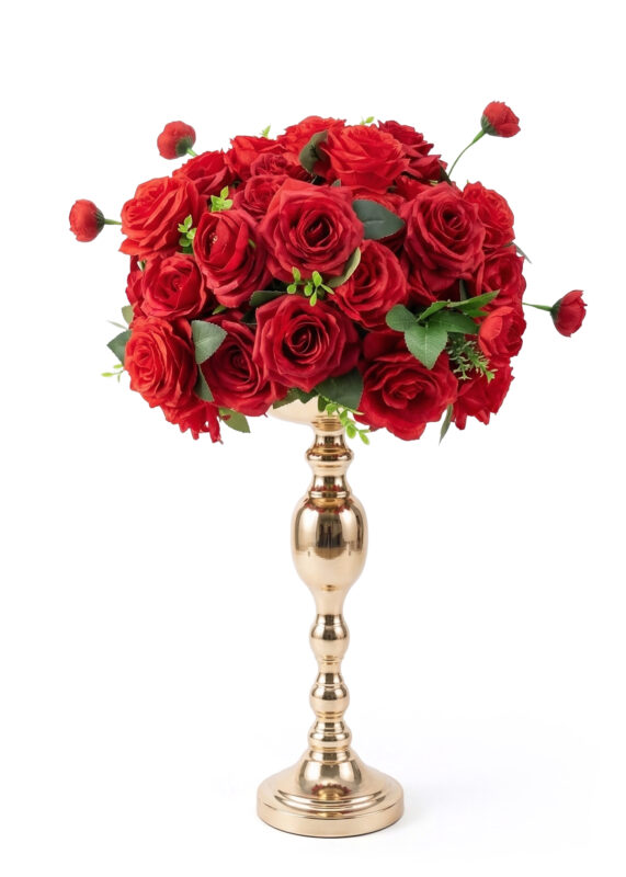 A bouquet of vibrant red roses forms a stunning flower ball with green leaves, arranged in an elegant, shiny gold vase with a tall, ornate stem against a white background.