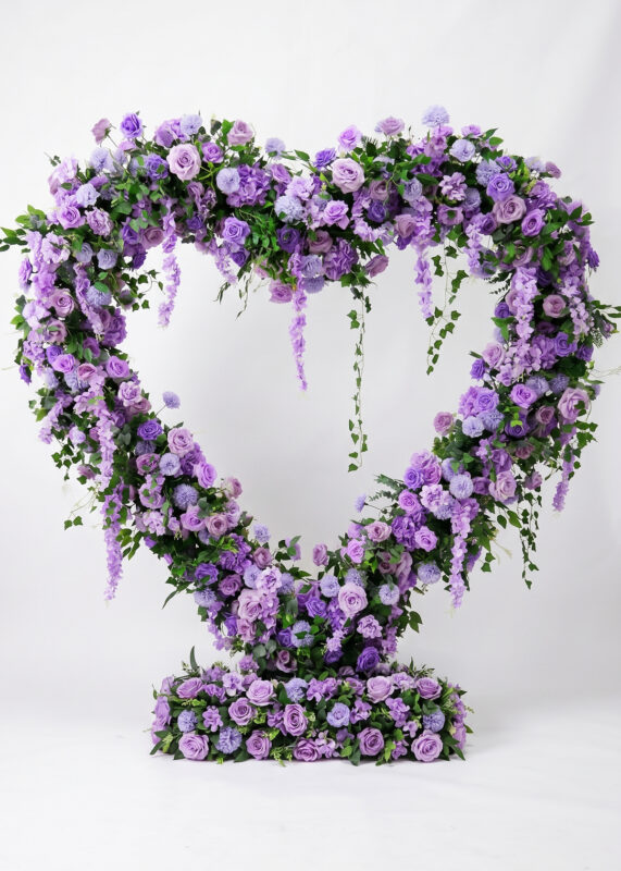 A large heart-shaped floral arrangement of purple and lavender roses sits against a white background, complemented by the Lavender Rose Hydrangea Floor Runner, Lush Elegant 40″x18″ Wedding Aisle Decor beneath.