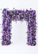 An 8ft Burgundy Red Rose Roll Up Flower Backdrop Set, a luxury romantic fabric floral arch with lush purple, lavender, lilac flowers, green foliage, and pops of burgundy red roses on a pipe stand for wedding decor-860829BDL2 (Copy), against a white background.