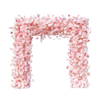 A large rectangular arch made entirely of pink and light peach roses, standing against a white background.