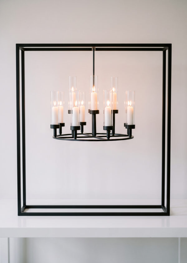 A 39.4in Black Square Frame Hanging Candelabra Centerpiece, Stunning & Elegant 12-Arm Wedding Table Stand featuring a black square metal frame surrounding a circular 12-arm candle chandelier with lit candles in glass cylinders.
