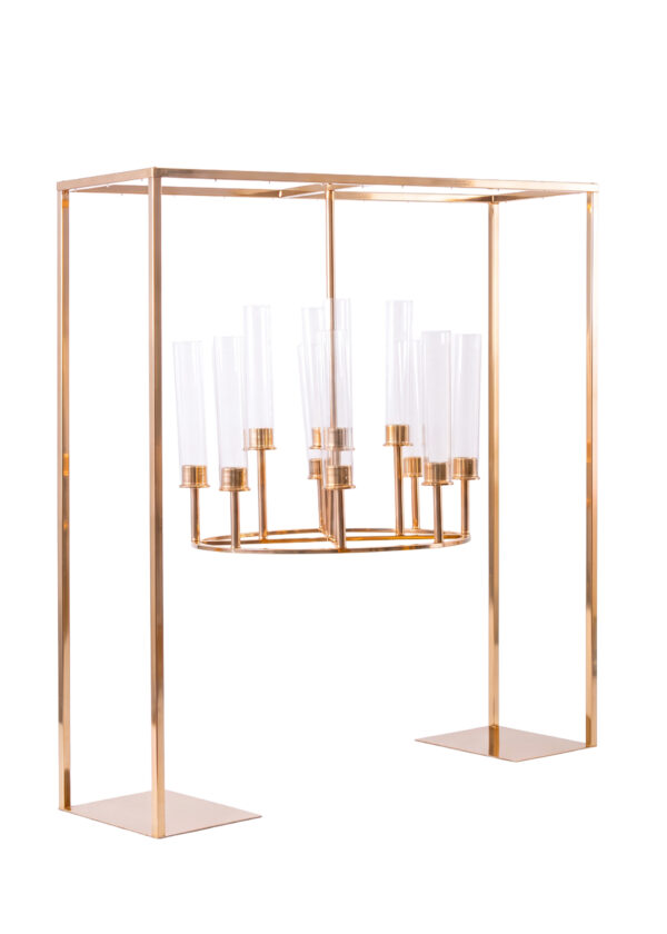 A gold-toned rectangular floor stand holding a circular chandelier with glass candle sleeves, serving as a black square hanging candelabra centerpiece stand.